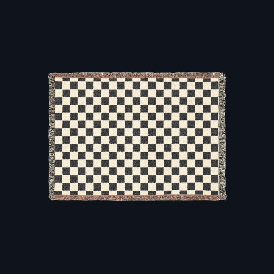 Black and cream geometric woven throw designed for modern quiet luxury interiors.